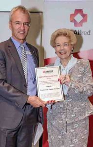 Professor Jamie Cooper - winner of the 2018 AMREP Research Prize for Clinical Research, receives his award from Dr Susan Alberti